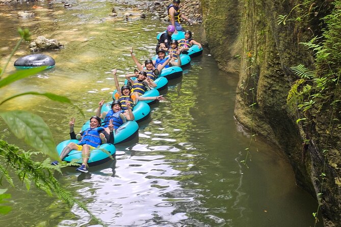 Rainforest Cave Tubing Adventure - Cave formations, river water, and waterfalls