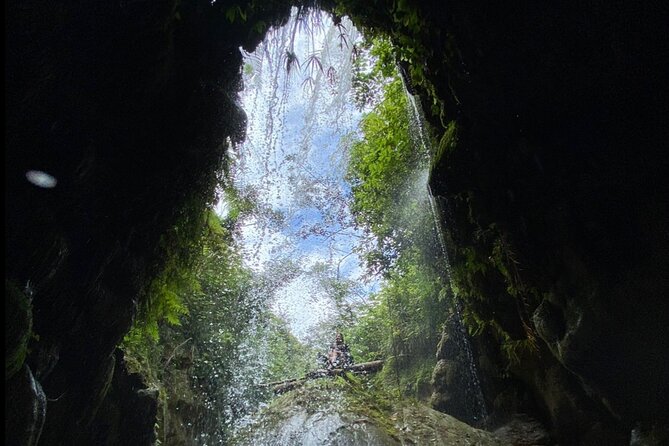 Rainforest Caves and Waterfalls Exploration with Transportation - Inside the caves: headlamps, water, and rock